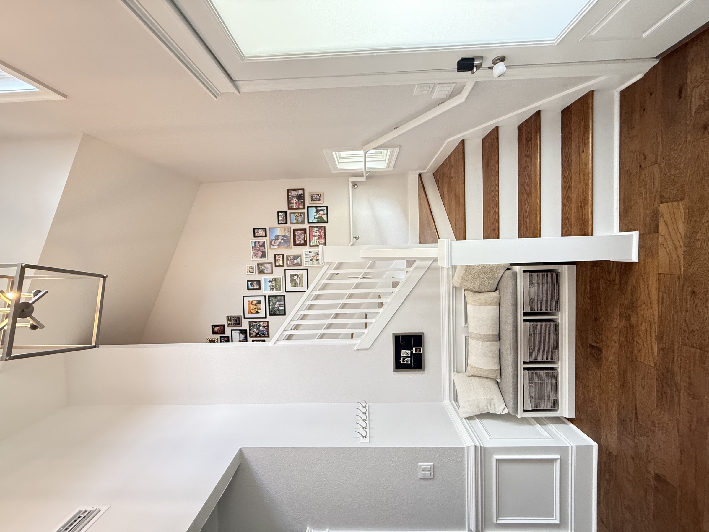 Hallway with hardwood floors and white trim