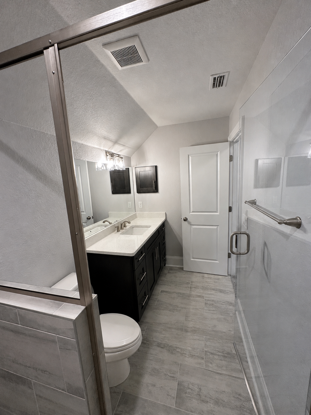 Second bathroom with vanity, tub and shower
