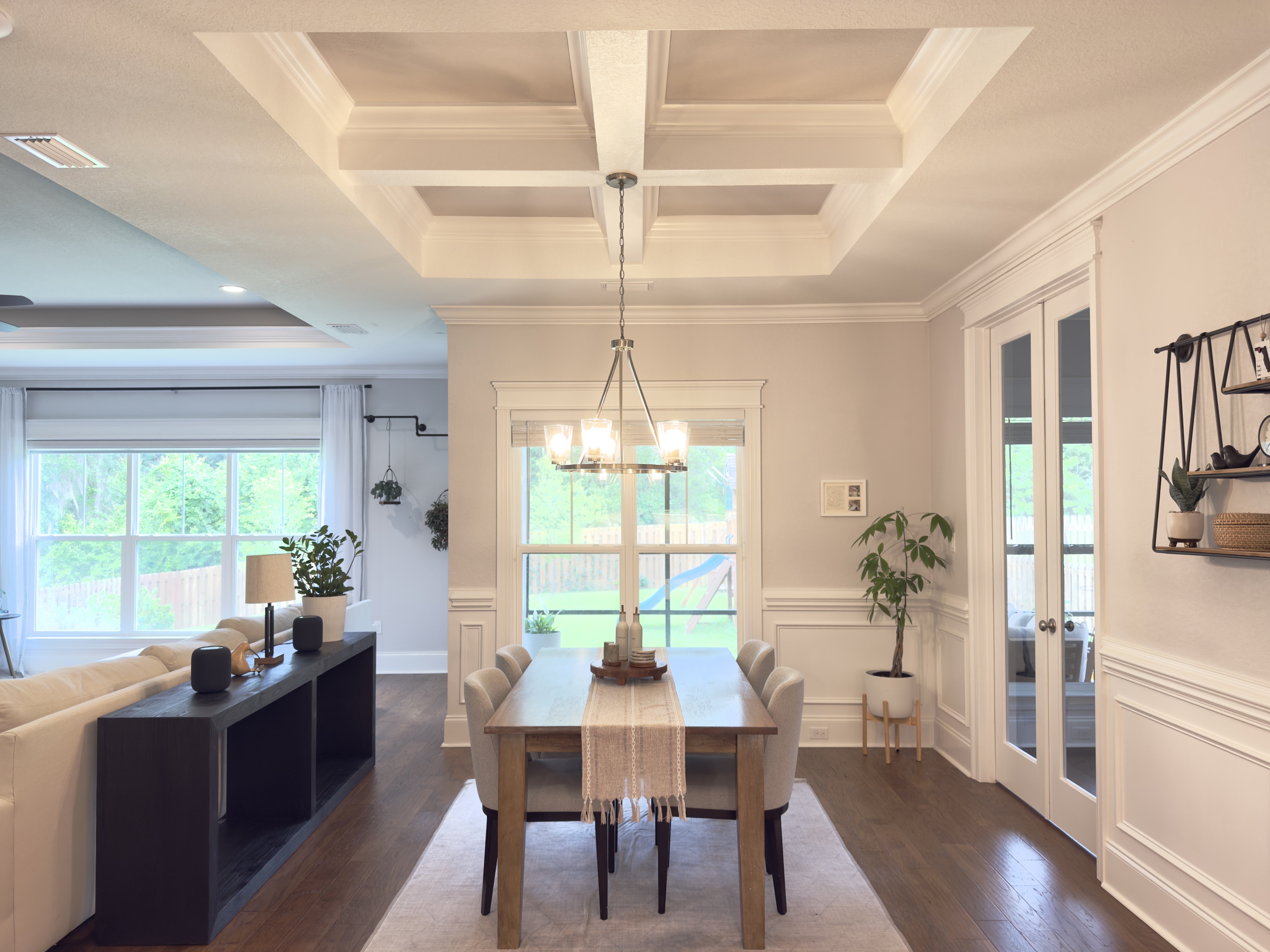 Dining area with coffered ceiling and chandelier