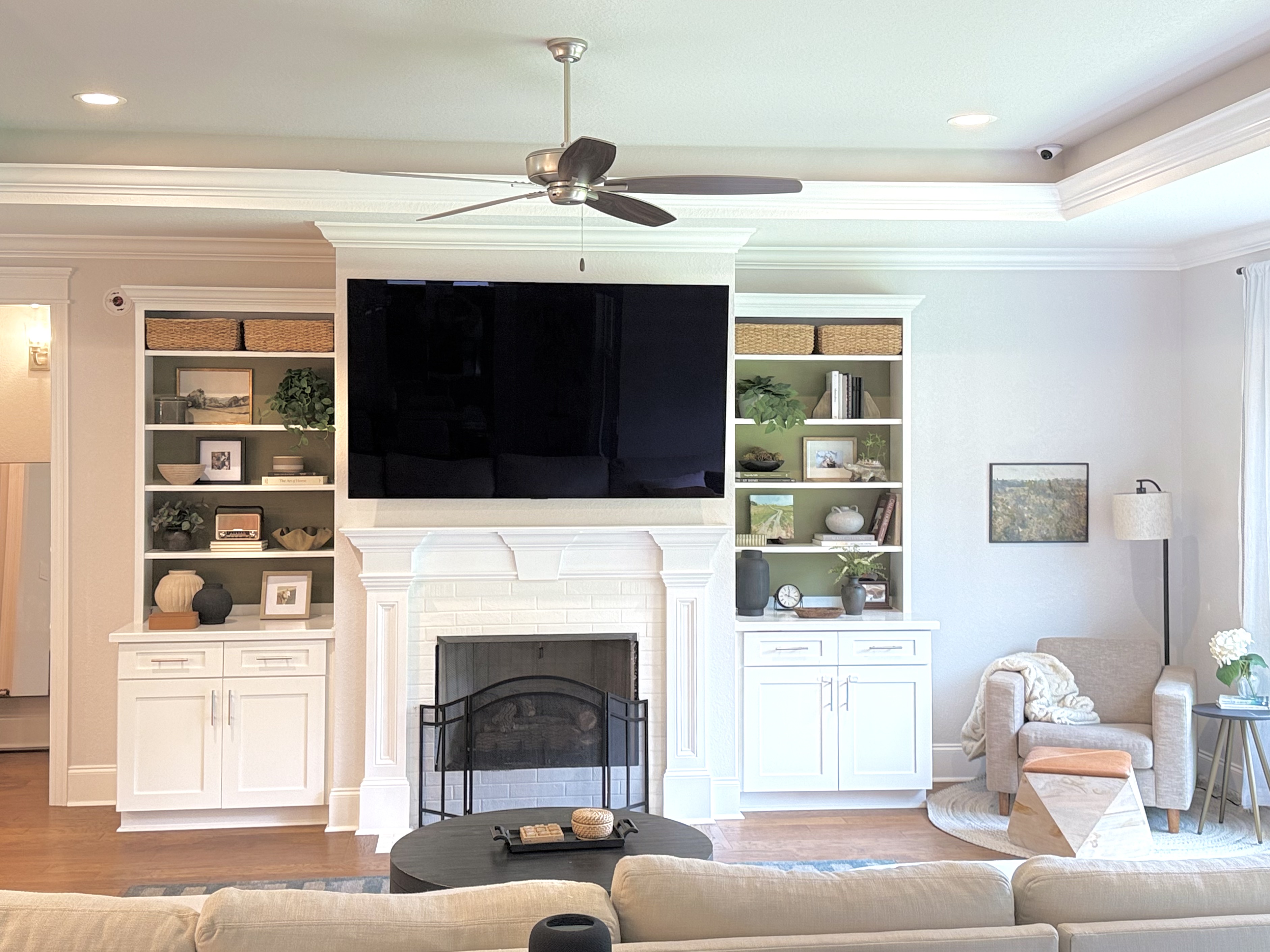 Living room fireplace wall with built-ins and mounted TV