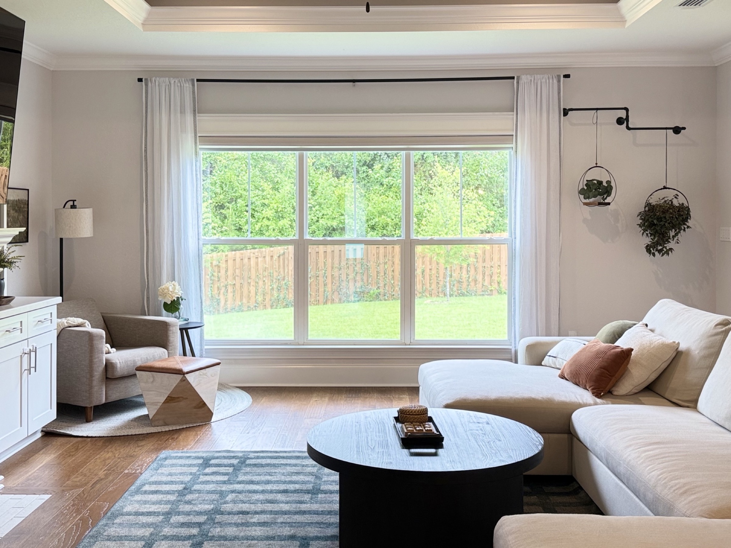 Bright living room with sectional and oversized picture window