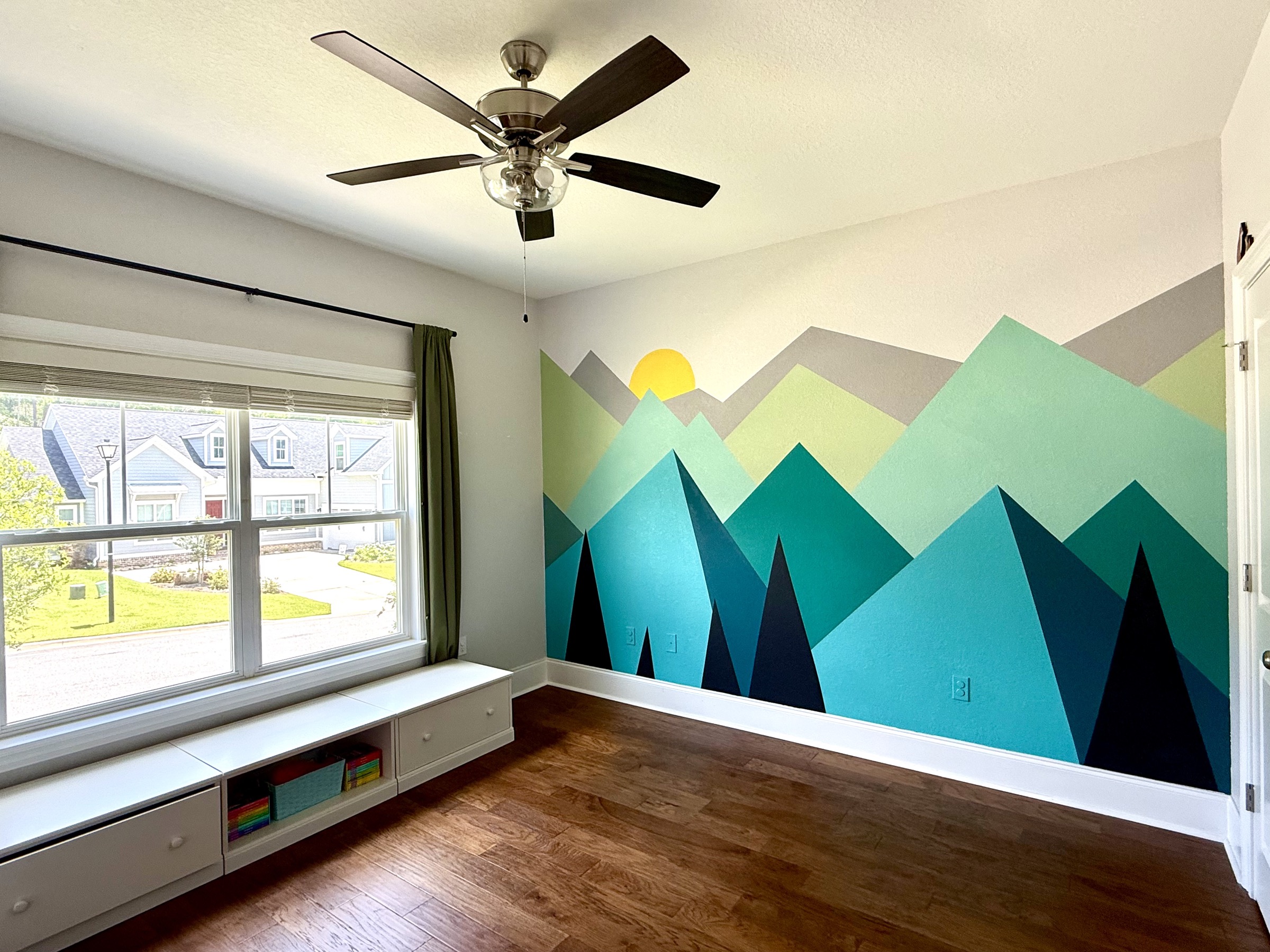 Secondary bedroom with hand-painted mountain mural and hardwood floors