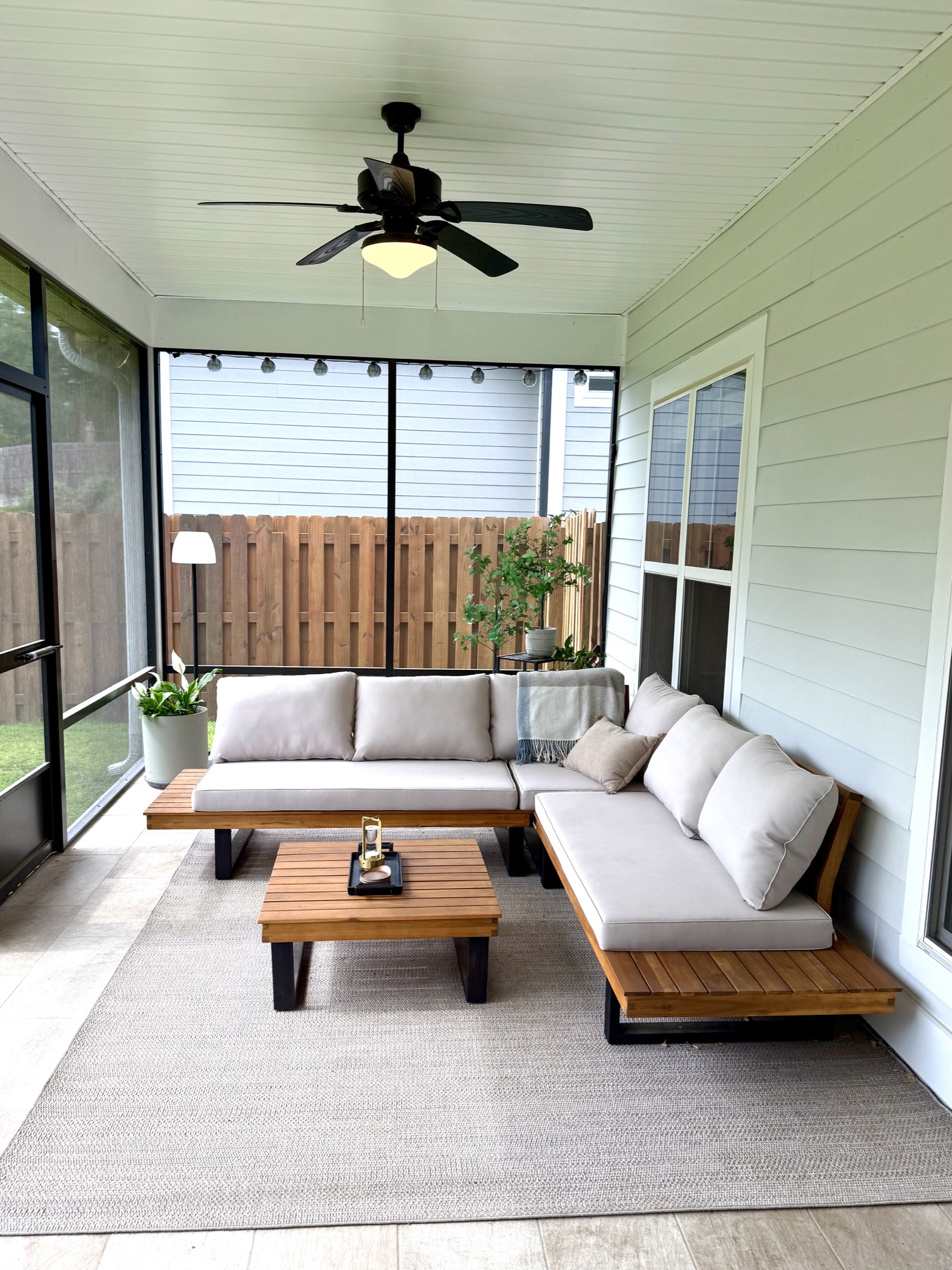 Screened back porch with seating area